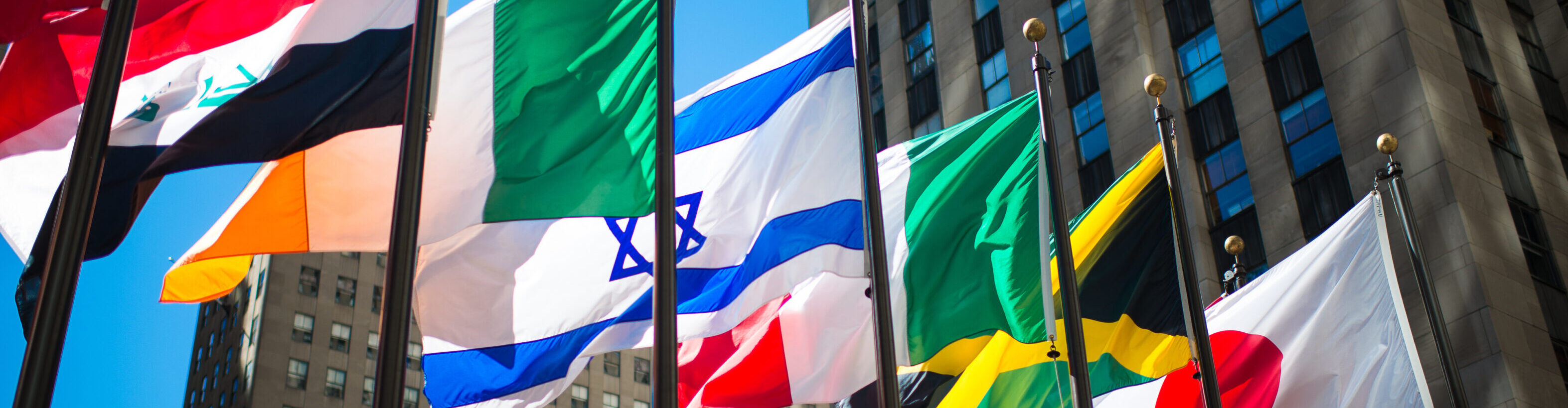 flags-from-around-the-world-surrounded-by-office-b-2025-01-10-02-15-07-utc-aspect-ratio-3840-1000